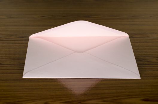 soft pink envelope on wooden background
