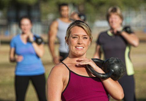 Close up of fitness instructor outdoors with students