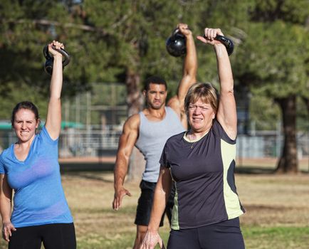 Mature white female exercising with kettle bell weights