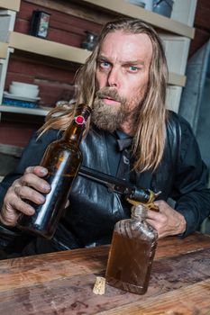 Drunk Western Man Aims Gun Towards Bottle as he Sits at Table