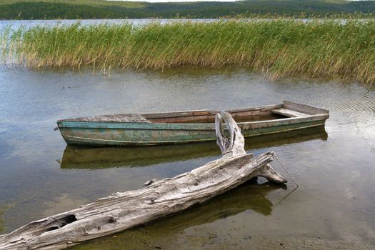 Old sunken boat off the coast of lake