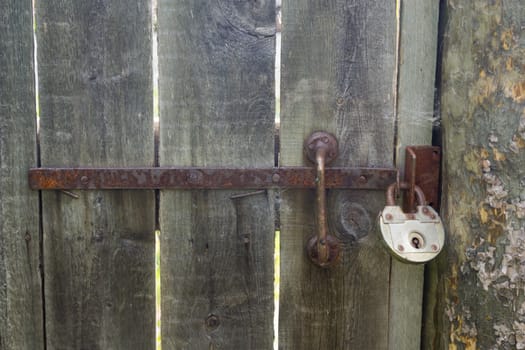 the old padlock on a wooden door