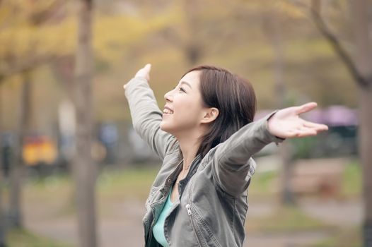 Asian beauty open arms and feel free in the city.