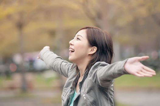 Asian beauty open arms and feel free in the city.
