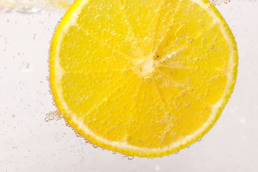 Glass citrus squeezer with lemons and juice