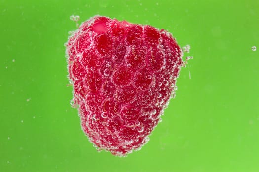 raspberries with bubbles in water