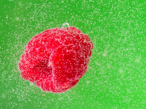 raspberries with bubbles in water