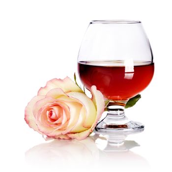 Glass and rose. Alcohol and flower. Glass with drink and a pink rose. Glass with alcohol and rose.