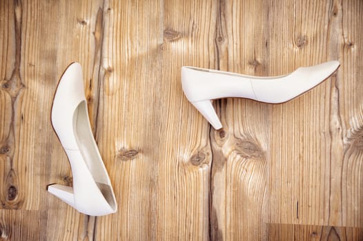 Pair of brides shoes on the wooden floor