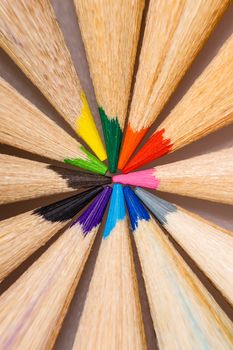 Brightly colored wooden pencils closeup shot background