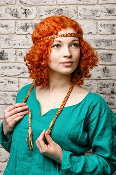 Attractive young girl with red hair in a studio portrait