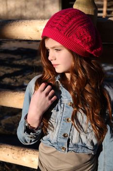 Teen winter girl wearing a red hat 