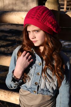Teen winter girl wearing a red hat 