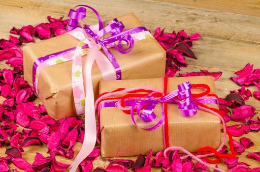 Fancy Valentines day gift boxes surrounded by dried flower petals