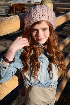 Teen girl outdoors on farm with horses 