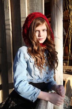 Teen winter girl wearing a red hat 