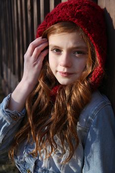 Teen winter girl wearing a red hat 