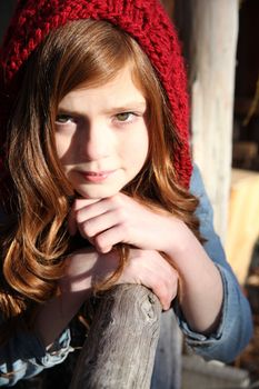 Teen winter girl wearing a red hat 