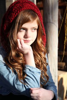 Teen winter girl wearing a red hat 