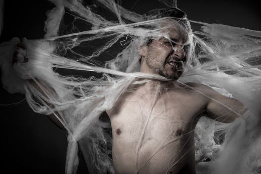 network. man tangled in huge white spider web