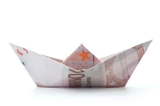 Paper boat made from Euro banknotes over a white background 