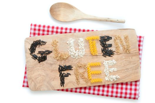 Gluten free grains including rice based pasta and oats over a chopping board 