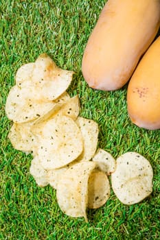 Fried potatoes, cut into pieces, mixed spices.on green grass