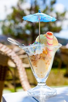 Caramel ice cream in cup outdoors