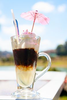 Iced coffee with ice-cream outdoors