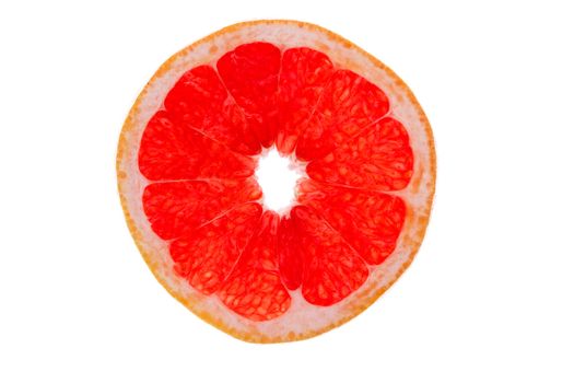 Colourful slice of ruby grapefruit isolated on white showing the succulent juicy pulp and structure of the vibrant pink segments