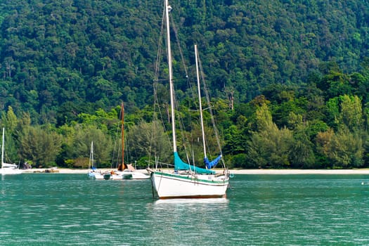 yacth anchored at green sea water