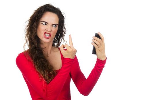 A very angry, annoyed and frustrated woman  giving the finger to the phone in rage. Isolated on white.