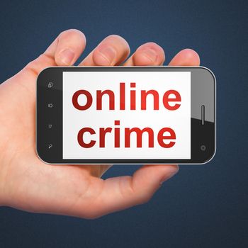 Security concept: hand holding smartphone with word Online Crime on display. Mobile smart phone on Blue background, 3d render