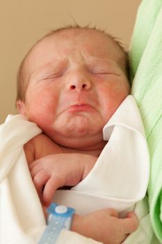 Loving mother hand holding cute sleeping newborn baby child