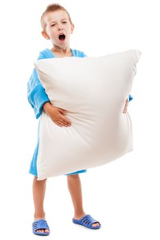 Little tired yawning child boy hand holding pillow going to sleep white isolated