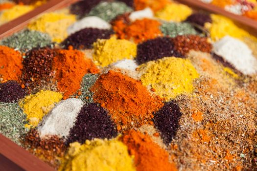 Multi color pepper powder and other herbal spice condiment ingredients at food market