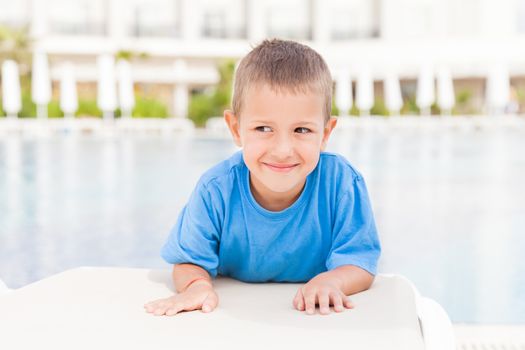Summer vacations - little smiling child boy at hotel pool