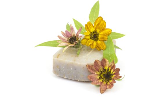 bar of natural soap and flowers