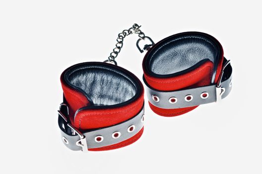 Red leather handcuffs in white background