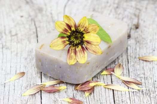 bar of natural soap and flowers