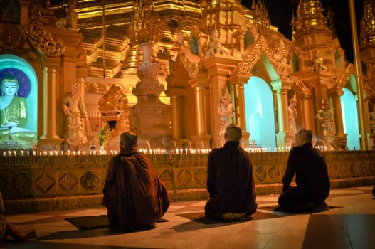 Three Monks Shwedagon Pagoda in Yangon City, Burma with Beautiful Evening Light: the beautiful golden pagoda, the oldest historical pagoda in Burma and the world, in the evening with great evening light.