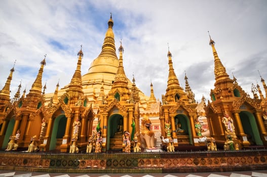 Shwedagon Pagoda Temple shining in the beautiful sunset in Yangon, Myanmar (Burma)  the beautiful golden pagoda, the oldest historical pagoda in Burma and the world, in the evening with great evening light.