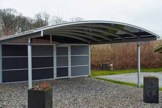 Modern carport car garage parking made from black metal and glass                               