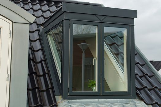 Modern design vertical roof window with black light metal covering                               