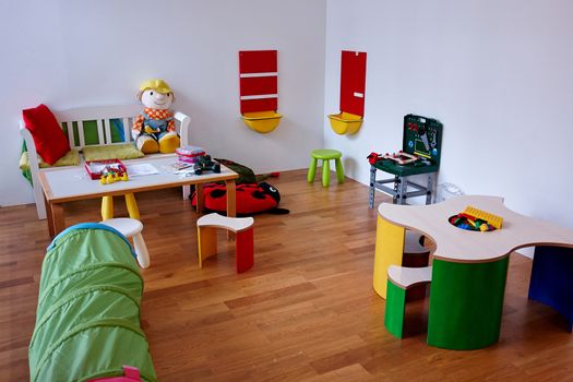 Colorful modern play children's room with variety of toys                               