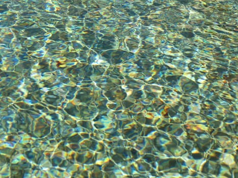 water surface with sunlight shining over it - useful as a background or holidays concept