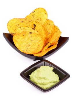 Arrangement of Tortilla Chips and Guacamole Sauce in Black Bowls isolated on White background