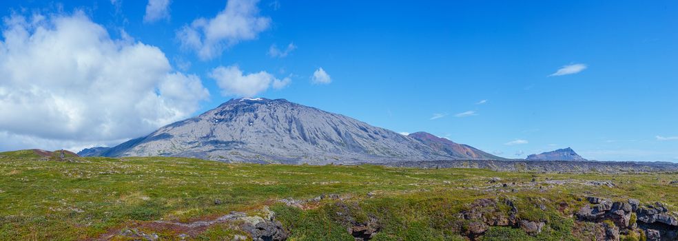 Iceland mountain cloudscape beautiful elongated clouds over Icelandic hills a sunny blue sky summers day picturing the ring road scenic tourism paradise travel landscape