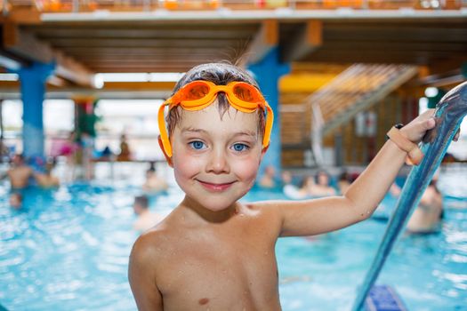 Activities on the pool. Cute boy in swimming pool