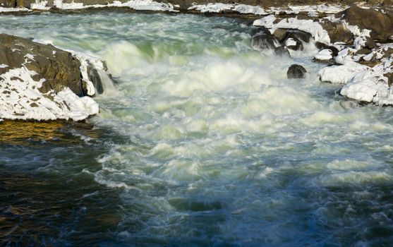 Great Falls on Potomac river outside Washington DC in winter with ice forming on the cascades and snow on the rocks